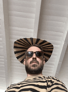 a man wearing a striped shirt and a hat