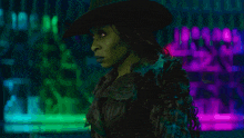 a woman with green hair and a purple jacket is standing in front of a green and blue background