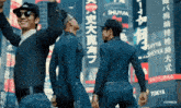 a group of men standing in front of a sign that says shiyubaa