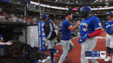 a blue jays player is being congratulated by his teammate
