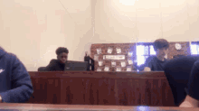 a man in a nike sweatshirt sits at a desk