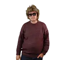 a man wearing sunglasses and a mullet looks at the camera