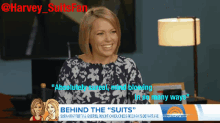 a woman is smiling in front of a sign that says " behind the suits "