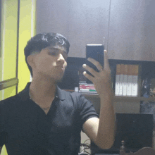 a young man taking a selfie with his phone
