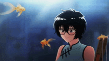 a girl wearing glasses is standing in front of a fish tank