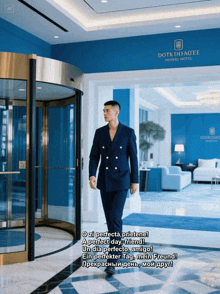 a man in a suit walks through a doorway of a hotel