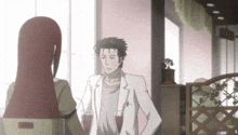 a man and a woman are standing next to each other in a room .