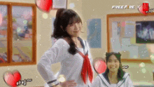 a girl in a school uniform is standing in a classroom next to a girl in a sailor suit .