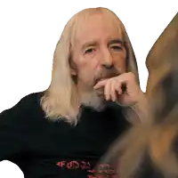 a man with long blonde hair and a beard is wearing a black shirt that says " for "