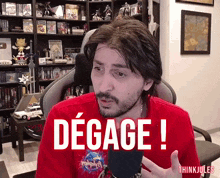 a man in a red shirt with the word degage on his shirt