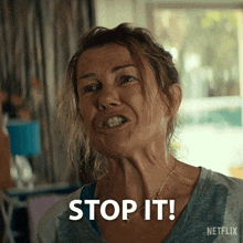 a woman is making a funny face and says stop it