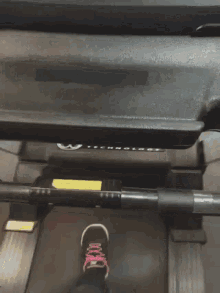 a person 's foot is on a treadmill that says infinity