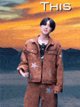 a man in a striped jacket and pants is standing in front of a sunset and the words this are above him