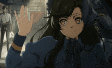 a girl in a blue dress is waving her hand in front of a man