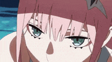 a close up of a pink haired anime girl with blue eyes looking at the camera .