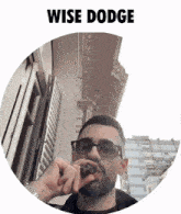 a man smoking a cigar in front of a building with the word wise dodge above him