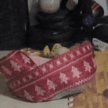 a red sweater with chinese characters on it is on a table