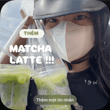 a woman wearing a mask is holding two cups of green matcha latte