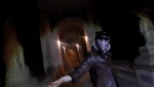 a blurry picture of a person standing in a dark room with a flashlight .