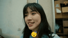 a girl with a smiley face on her neck and jkt48 written on the bottom