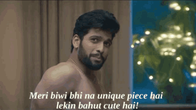 a shirtless man with a beard says 
