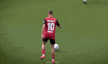a soccer player wearing a green jersey with the number 2