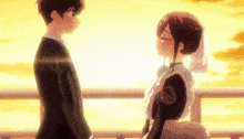 a man and a woman are standing next to each other and kissing .