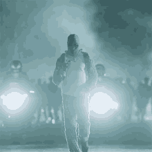 a man wearing a mask is walking in front of a crowd