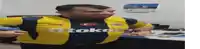 a man wearing a yellow and blue shirt that says otokar on it