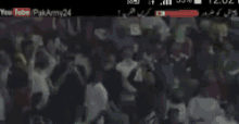 a phone screen shows a man walking in front of a sign that says youtube pakarmy24