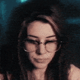 a close up of a woman wearing glasses
