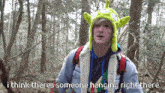 a man wearing a toy story hat says i think theres someone hanging right there