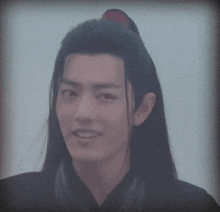 a close up of a man with long hair
