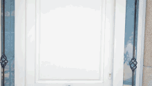 a white door with a wrought iron decoration on the side