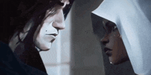 a man and a woman are looking at each other with tears coming out of their eyes .