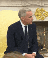 a man in a suit and tie sits on a yellow chair