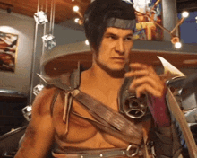 a man in a warrior costume holds a sword in his right hand