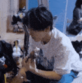 a young man is sitting on the floor eating a piece of food
