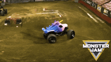 a monster jam truck with a pink and blue unicorn on top