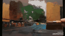 a painting is being painted with a spatula and the words made in animatica are visible