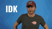 a man wearing a hat and a t-shirt with the word idk on it