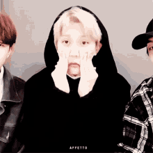 a man in a black hoodie is making a face