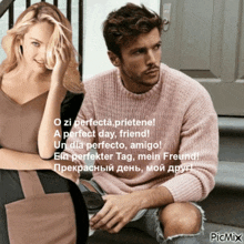 a man in a pink sweater sits next to a woman in a black dress