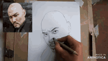 a drawing of a bald man with a beard is being made by animatica
