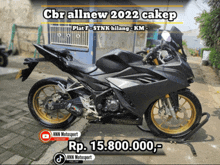 a black honda motorcycle is parked on the sidewalk