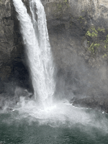 a waterfall is coming down the side of a cliff