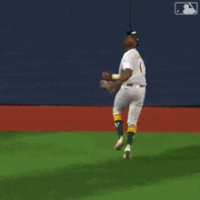 a baseball player with the number 1 on his jersey is jumping in the air