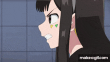 a girl with a green yellow and white triangle on her face is eating a cake