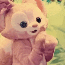 a close up of a stuffed animal with a bow on its head and a bow on its head .