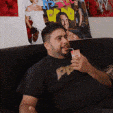 a man sitting on a couch drinking from a carton that has the word pp on it